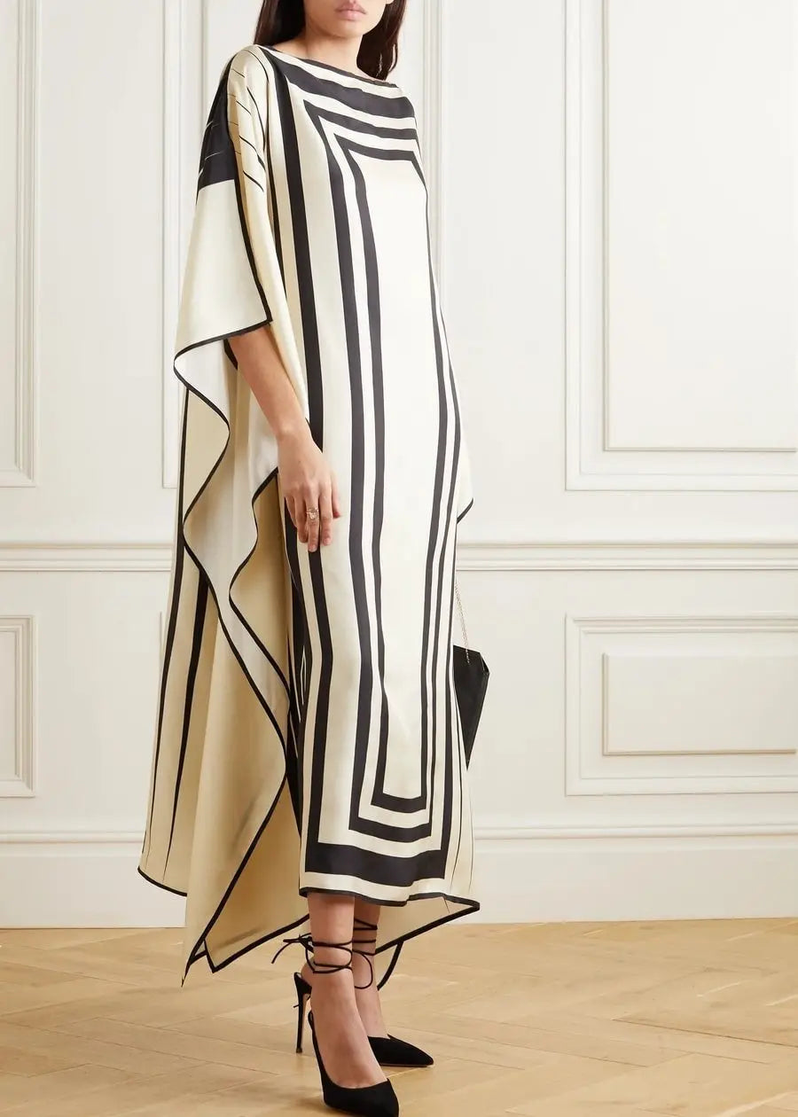 Woman wearingVicharan Elegant Black & Cream caftan in an elegant room.