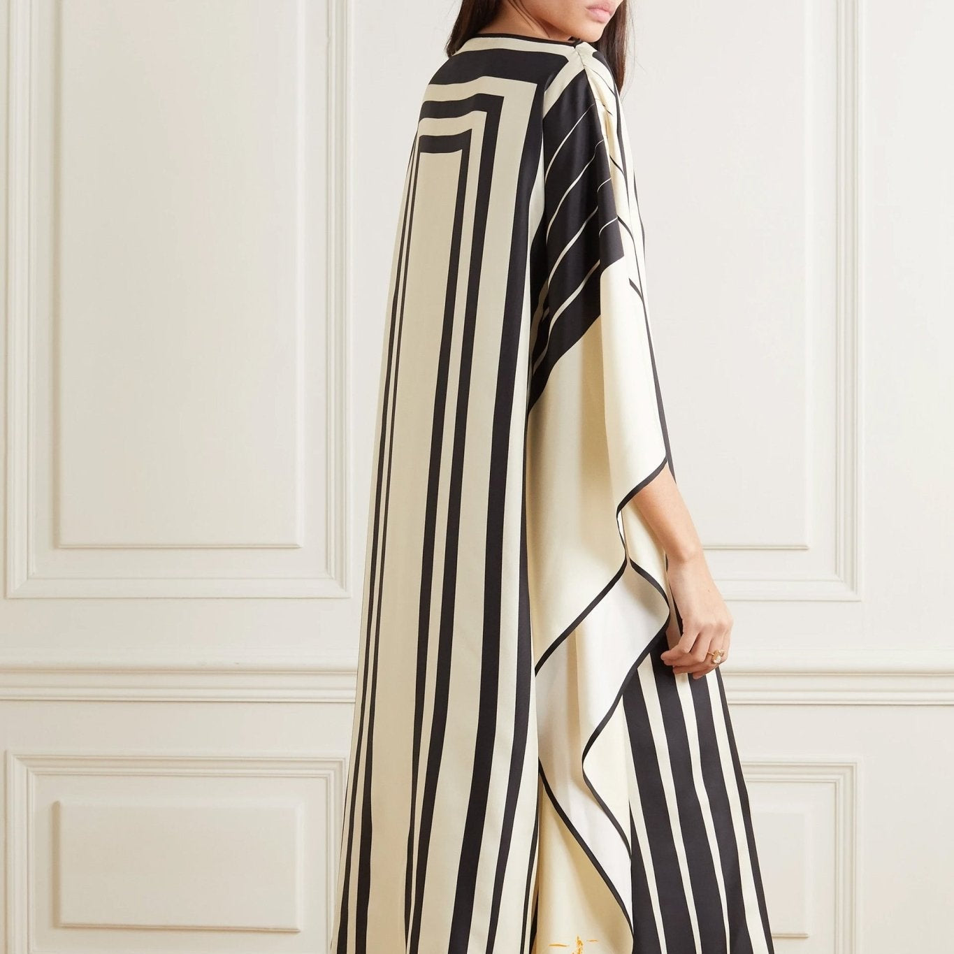 Woman wearing Vicharan Elegant Black & Cream caftan in an elegant room.