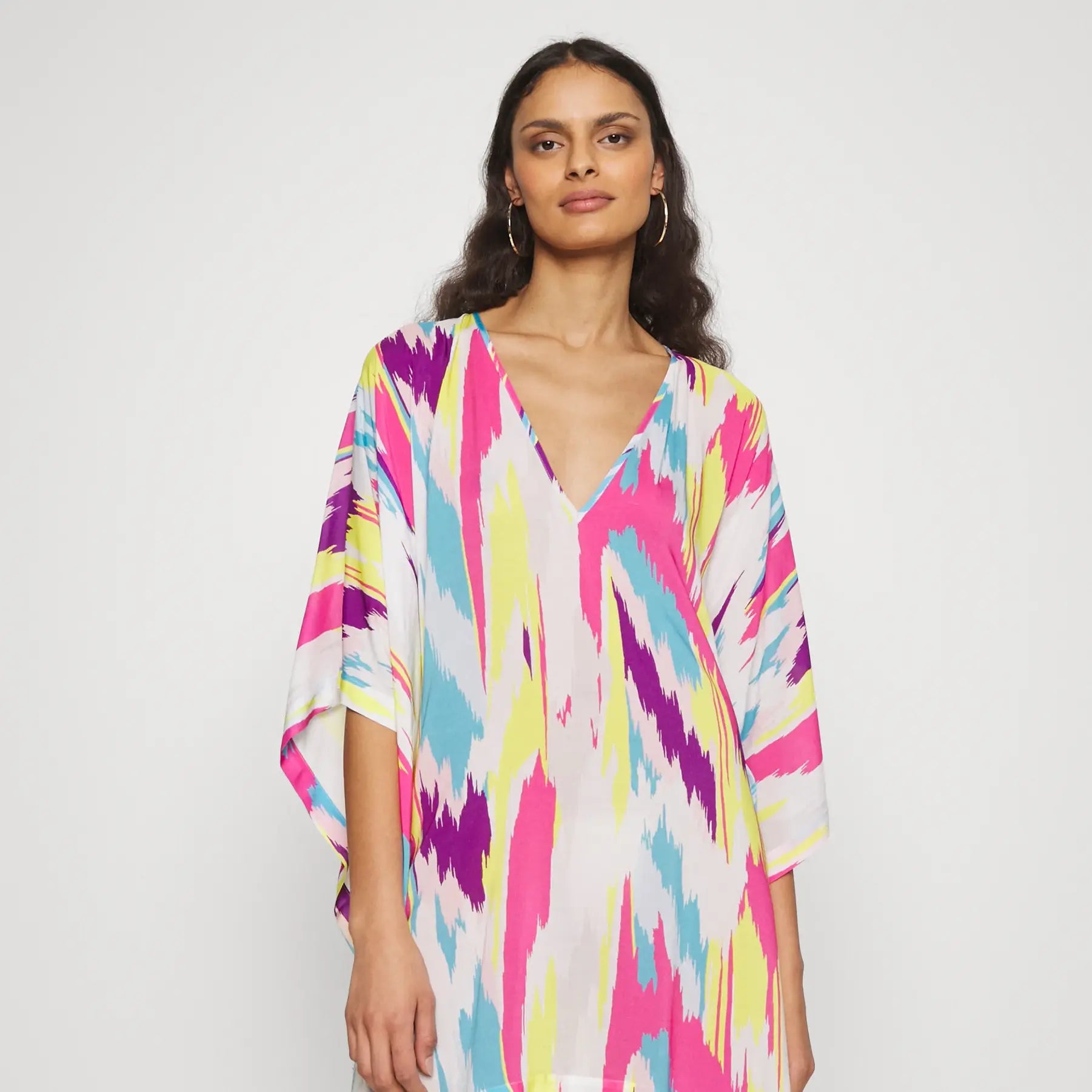 Womanwearing Vicharan PRISM Light Tunic on a white background